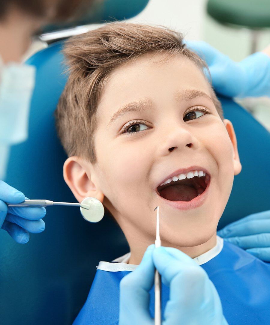 A child smiling during a dental examination